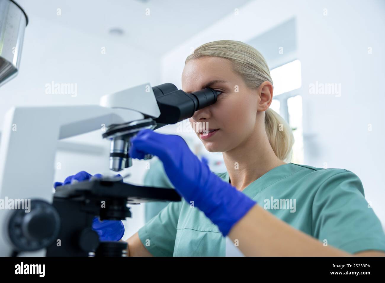 Docter Using Science Doctor in clinic focused on scientific study using microscope for ...