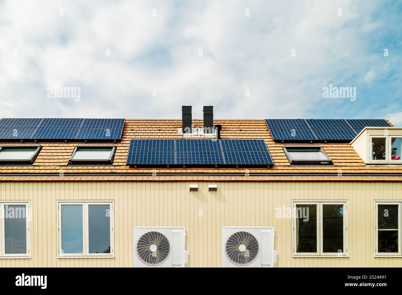 Row of new Dutch houses with solar panels and air-source heat pumps Stock Photo