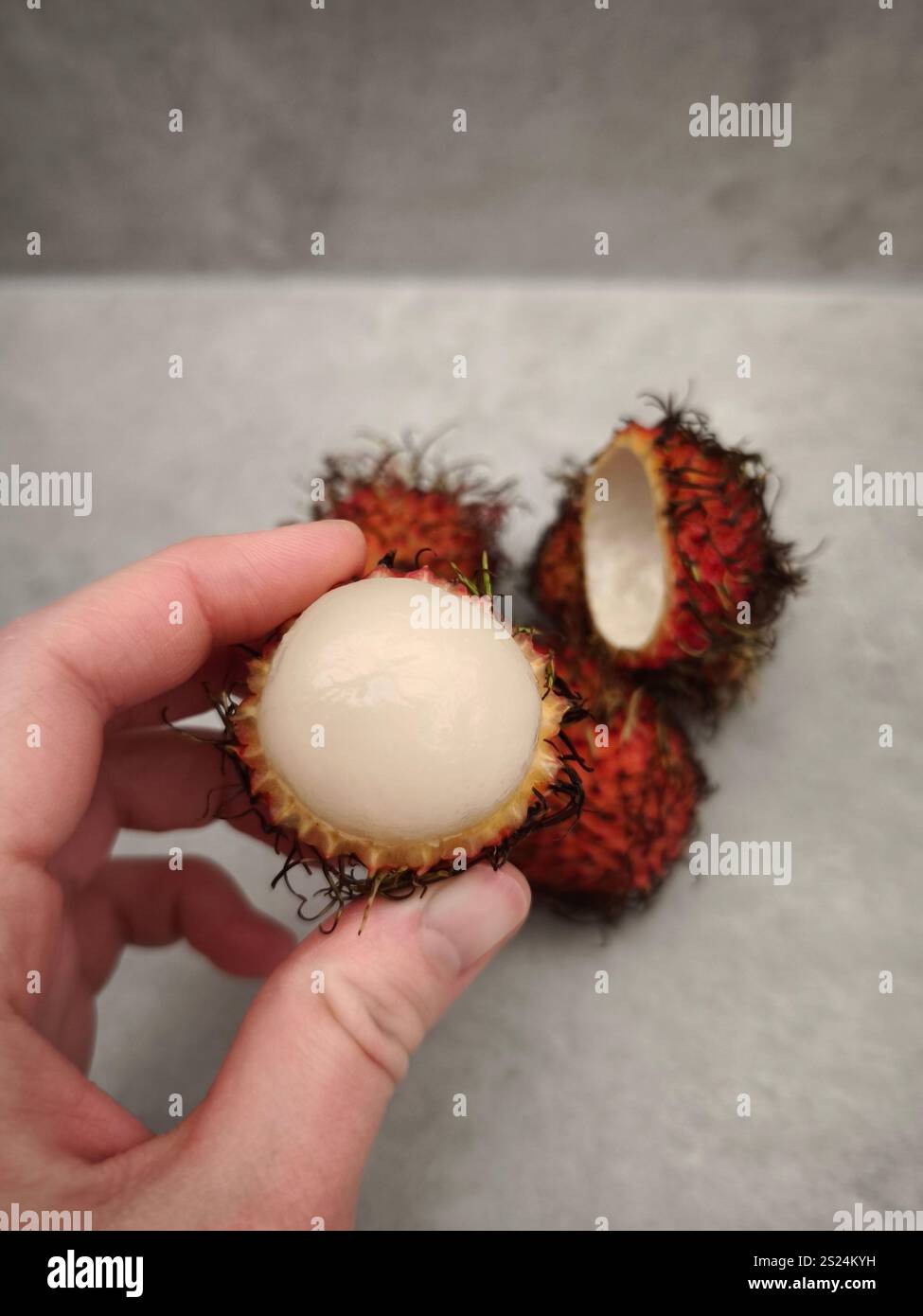 Hand holding peeled rambutan fruit hi-res stock photography and images ...