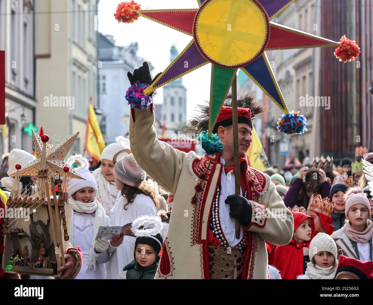 Krakow, Poland. 06th Jan, 2025. A man holds a symbolic star as crowds ...