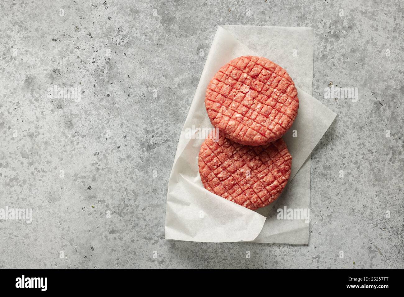 fresh raw burger meat on grey kitchen table, top view Stock Photo