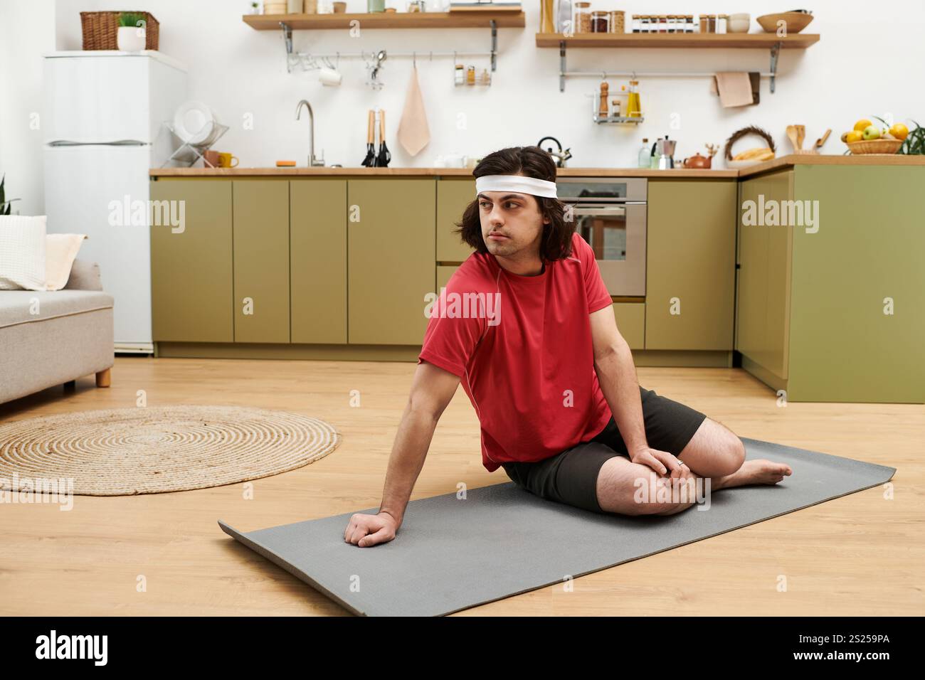 His Routine Young man practices fitness routines at home, showcasing his healthy ...