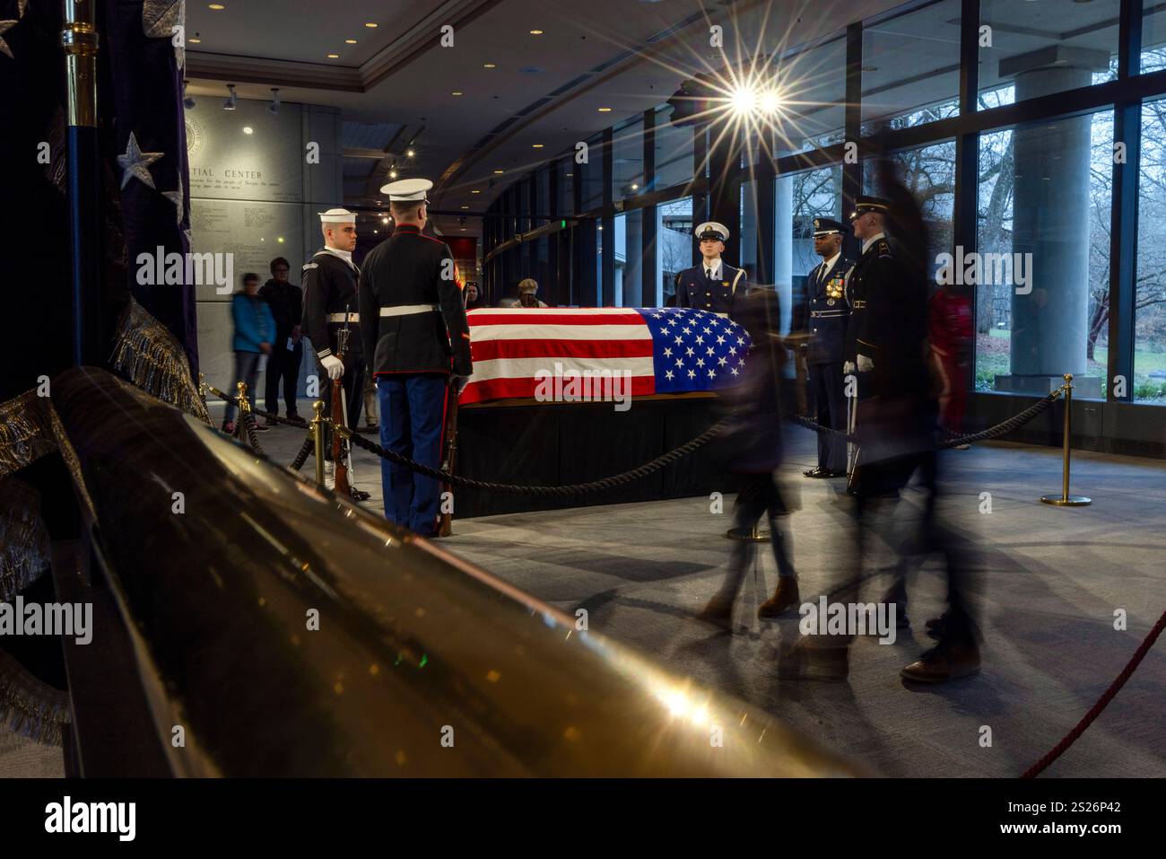 Mourners view the casket of former President Jimmy Carter as he lies in