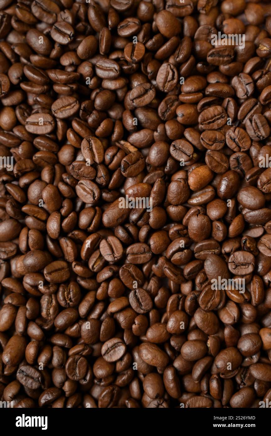 Top view closeup roasted coffee beans. Vertical copy space background, cover, backdrop, texture. Place for adding text or design Stock Photo