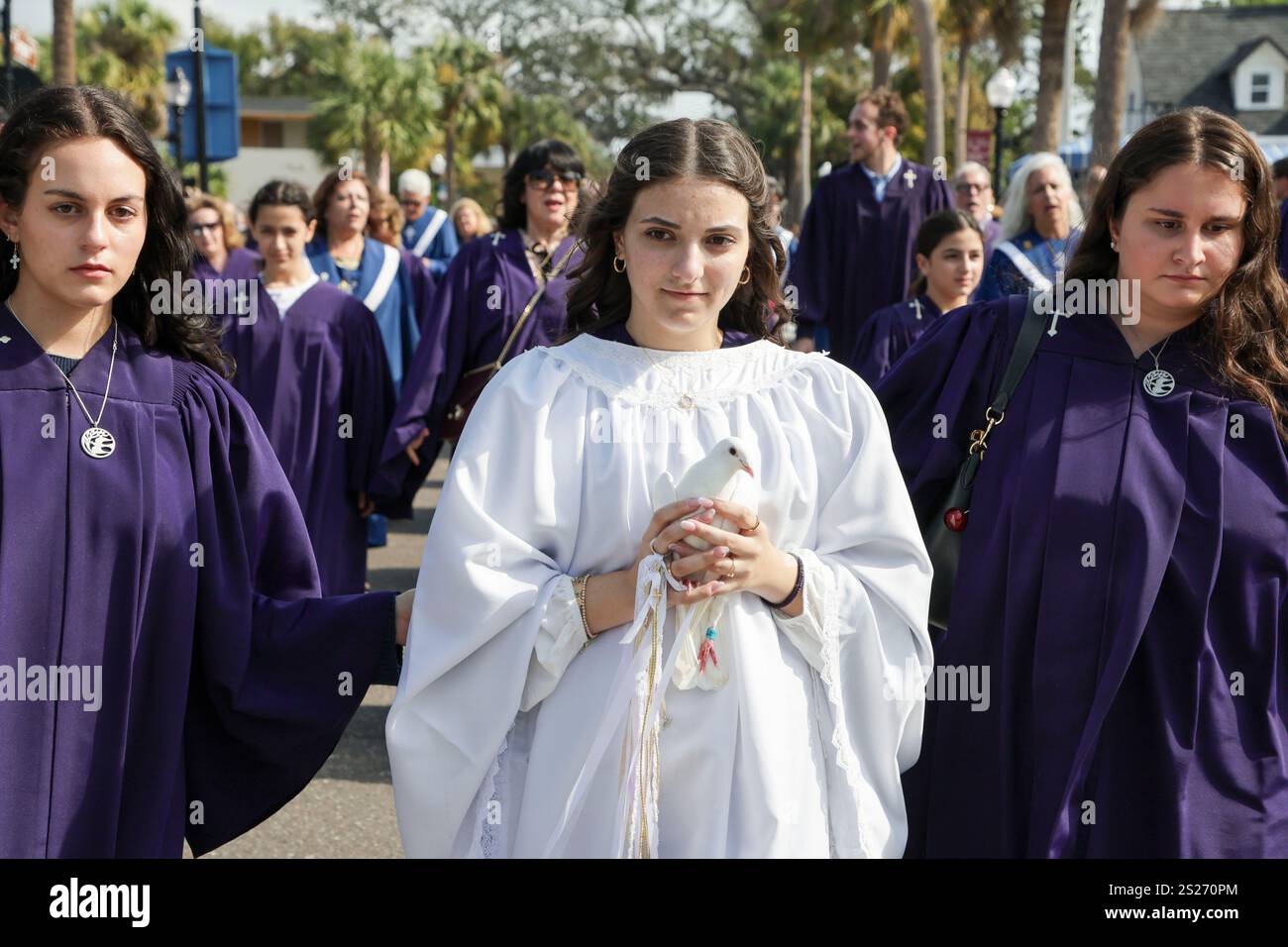 Dove bearer Michalia Makryllos, center, joins a procession to Spring