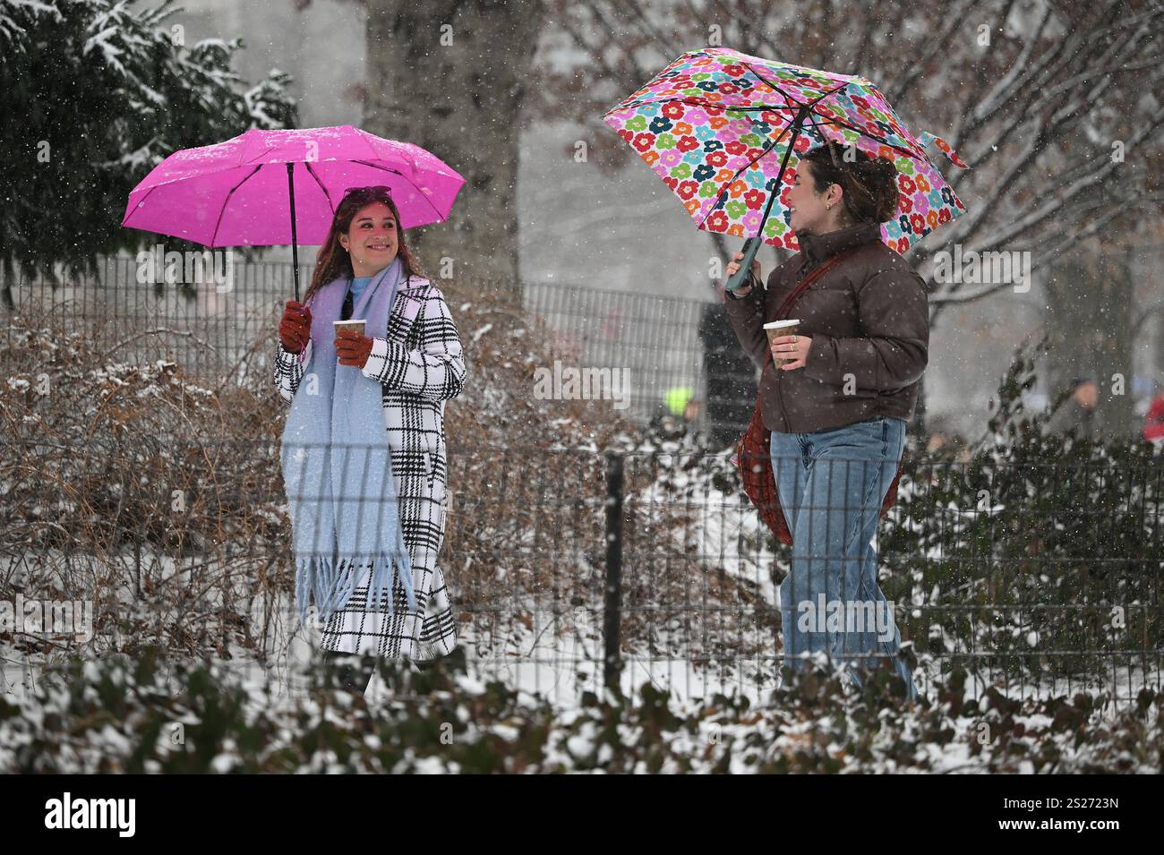 People walk through Central Park as a winter storm blankets New York ...