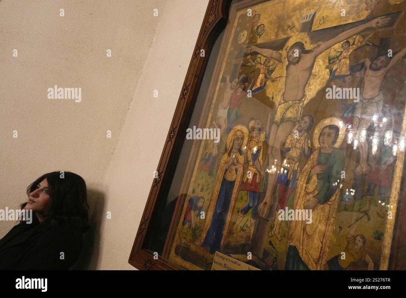 A Coptic Orthodox worshipper attends prayers at Virgin Mary Church in Cairo, Egypt, Monday, Jan
