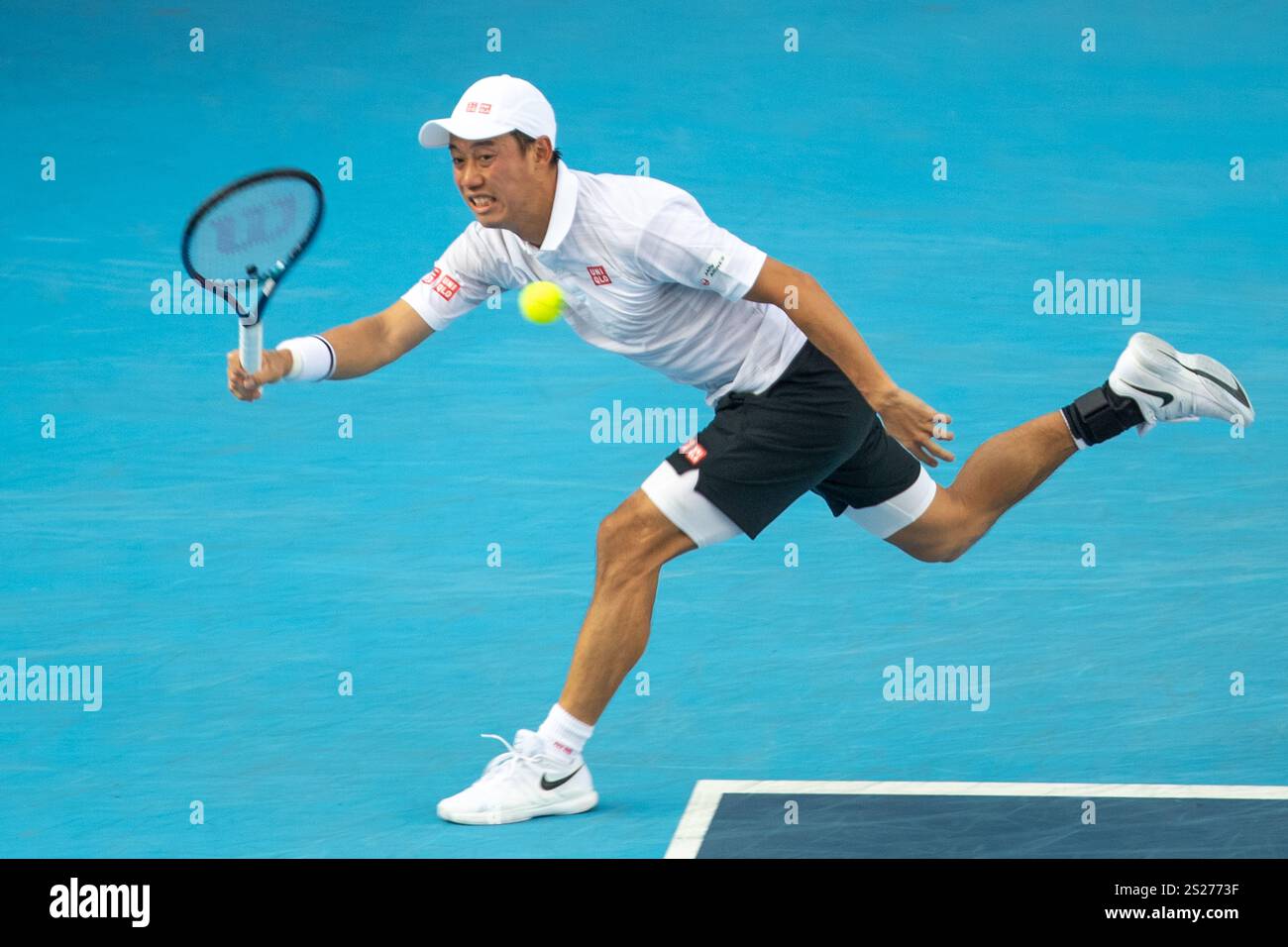 Kei Nishikori of Japan return a shot to Alexandre Muller of France ...