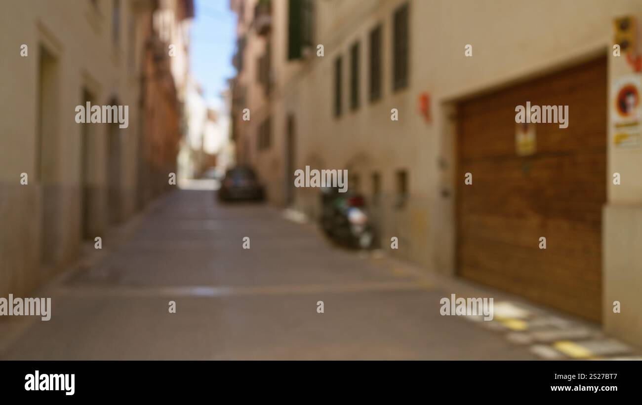 Blurred street scene in mallorca with defocused buildings and cars ...