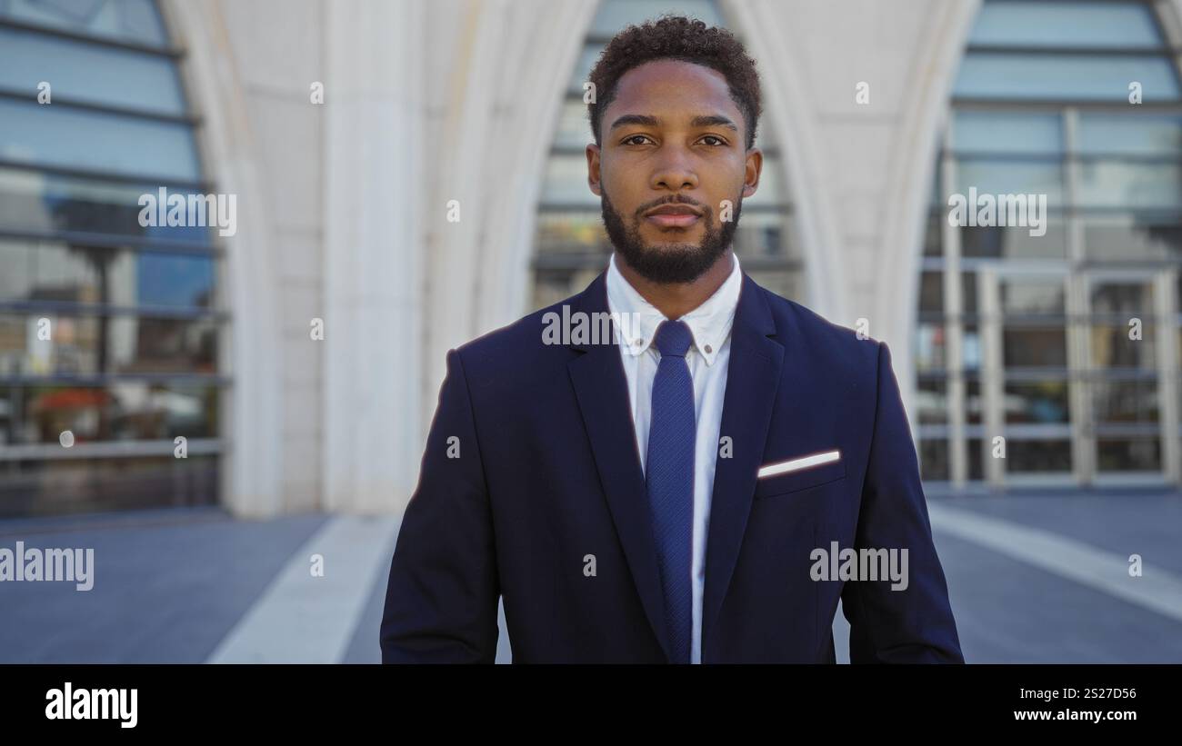 Young man standing confidently outdoors in an urban setting wearing a ...