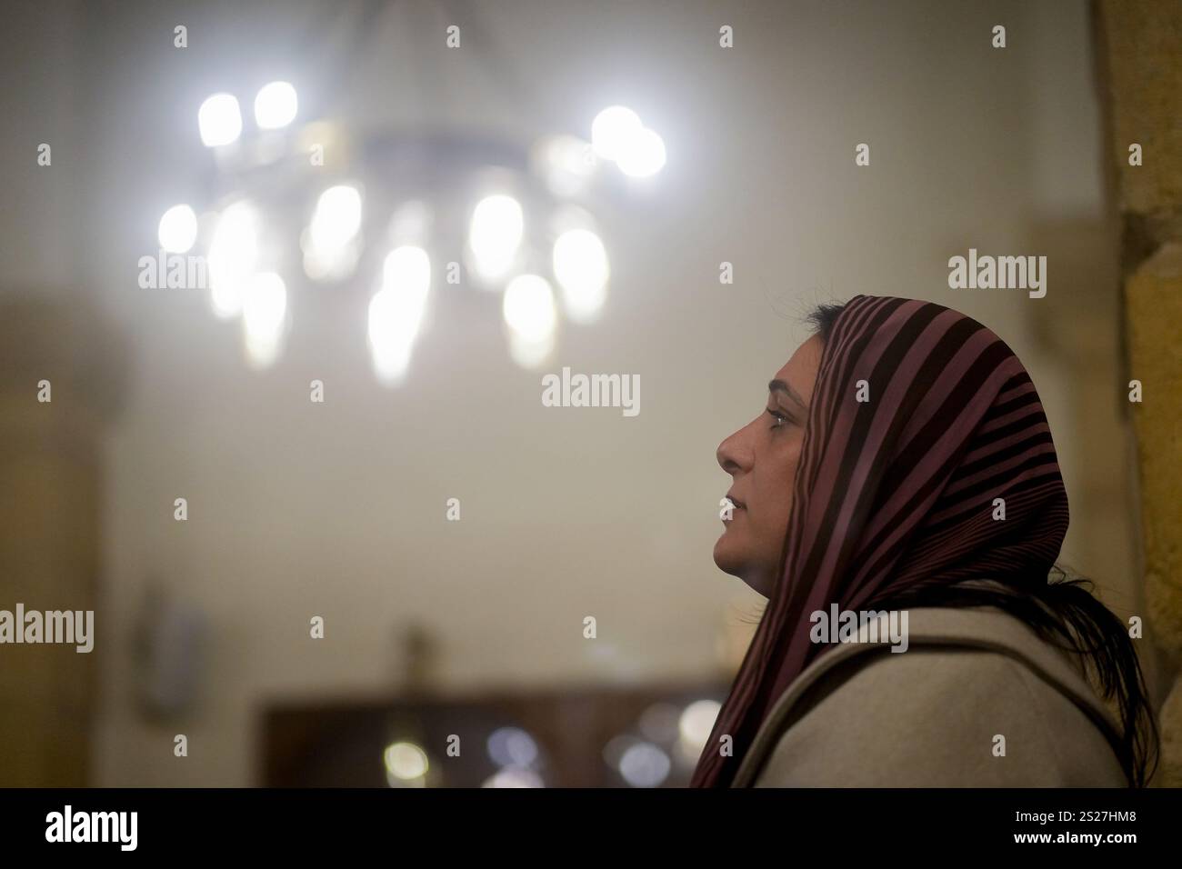 A Coptic Orthodox worshipper attends prayers at Virgin Mary Church in Cairo, Monday, Jan. 6