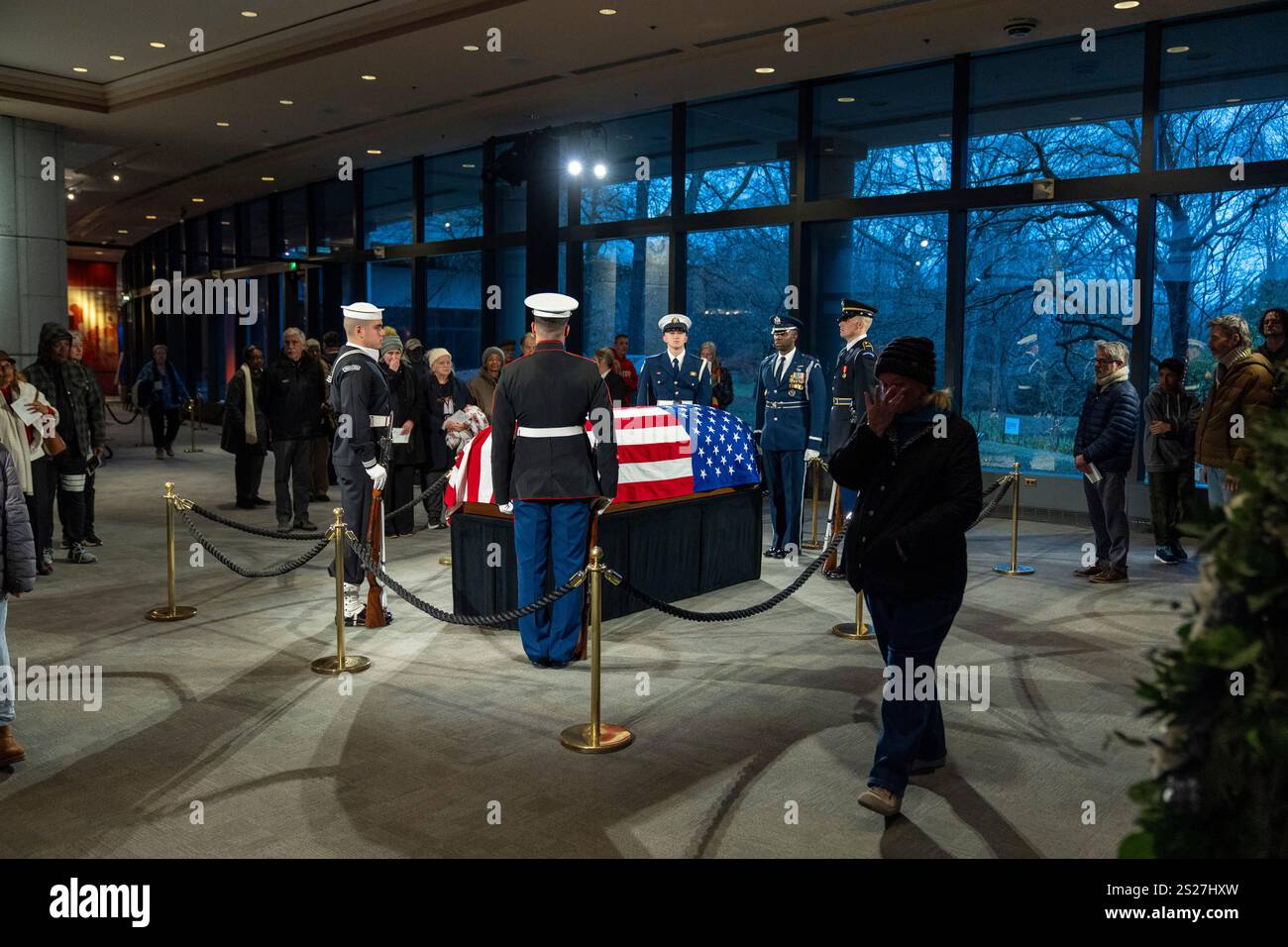 Mourners view the casket of former President Jimmy Carter as he lies in