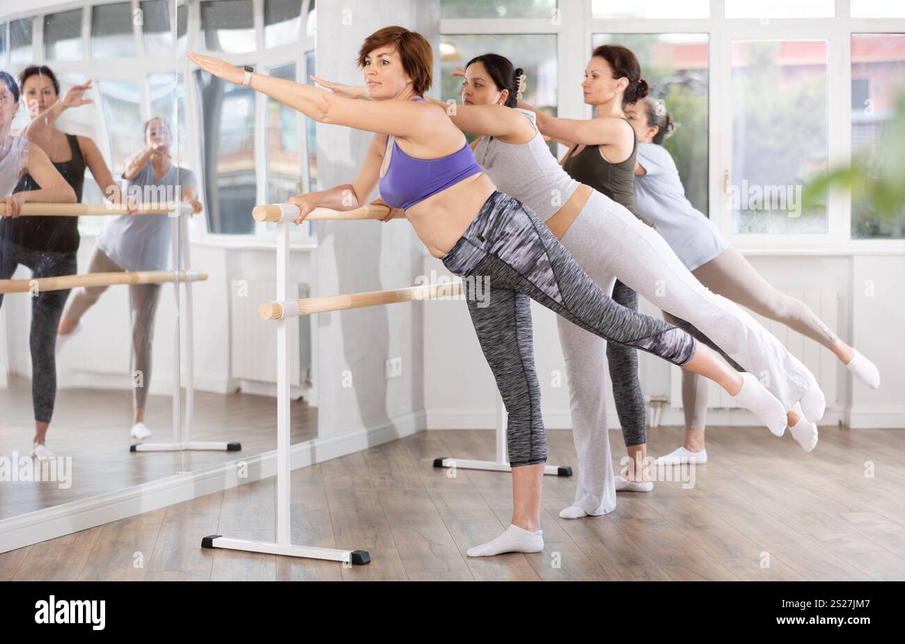 Group of women beginners practicing at ballet barre Stock Photo