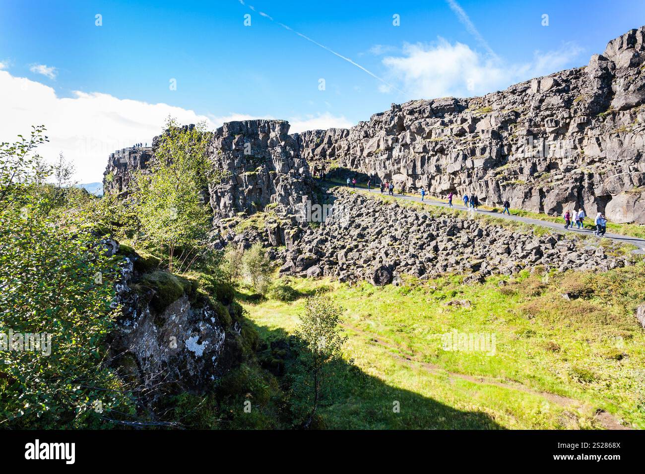 travel to Iceland - tourists on road in Almannagja gorge in Thingvellir ...