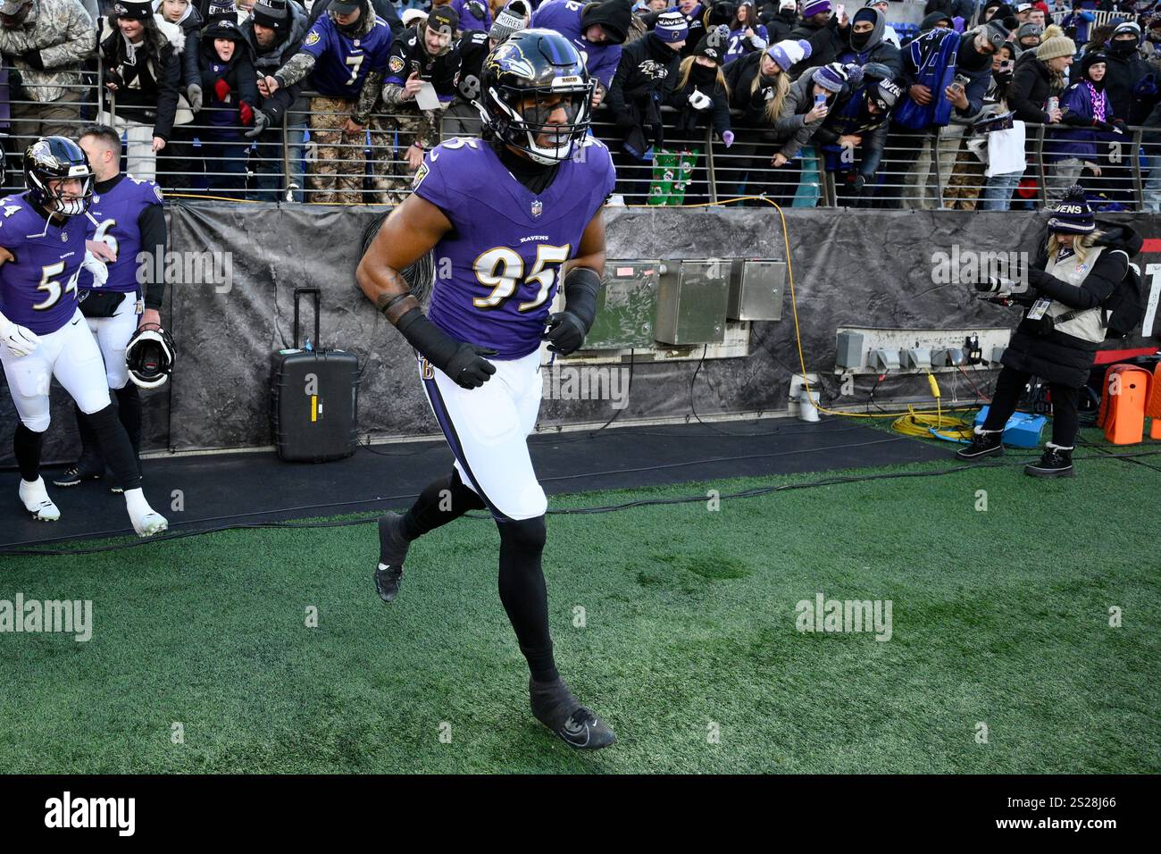 Baltimore Ravens linebacker Tavius Robinson (95) takes to the field to