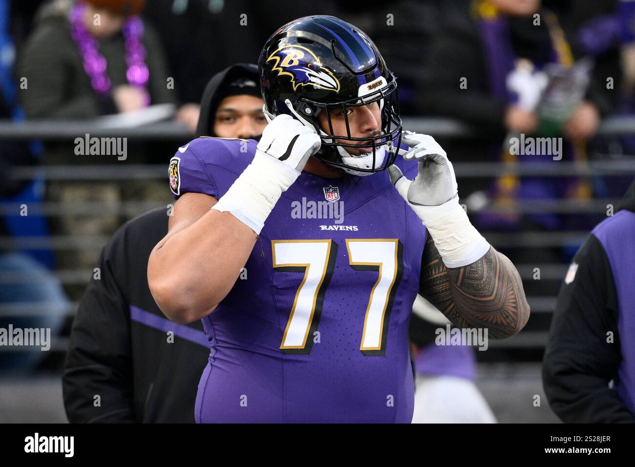 Baltimore Ravens offensive tackle Daniel Faalele (77) works out before ...