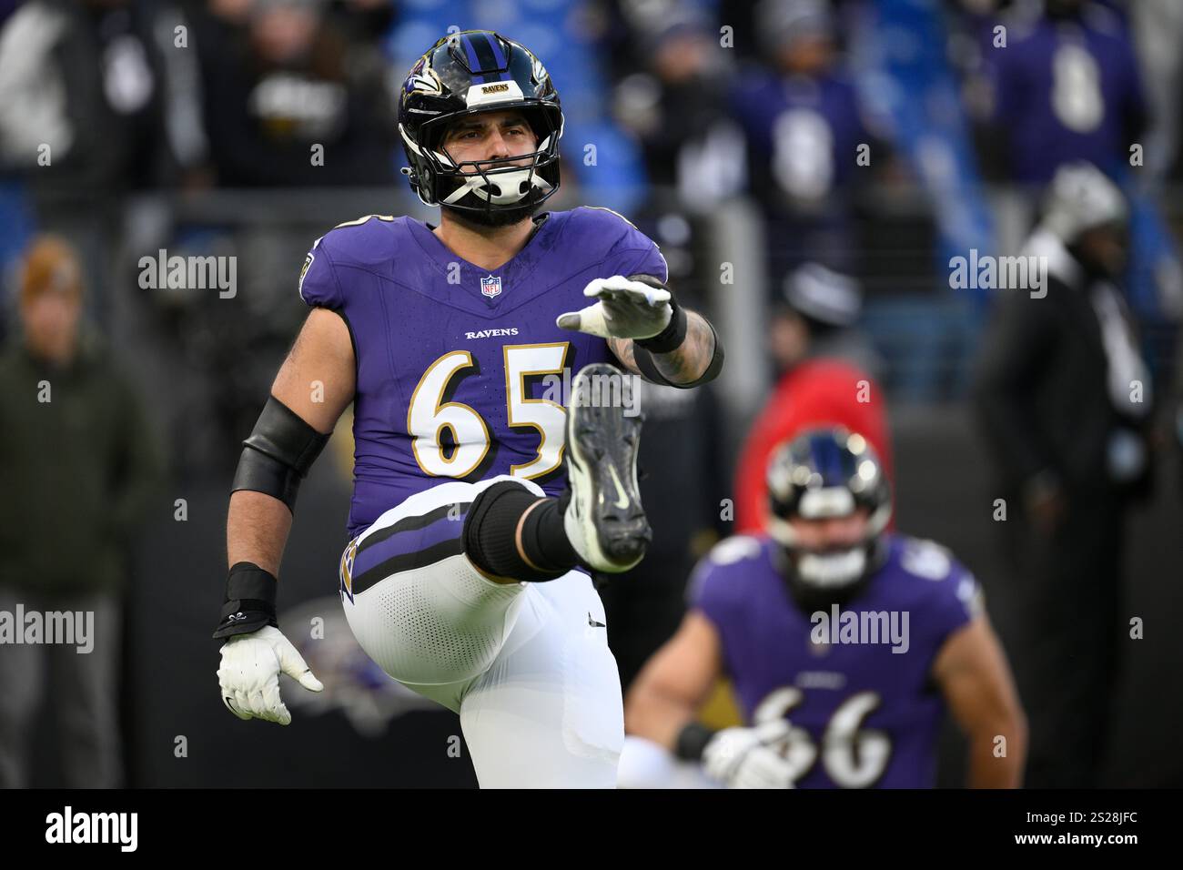 Baltimore Ravens guard Patrick Mekari (65) works out before an NFL
