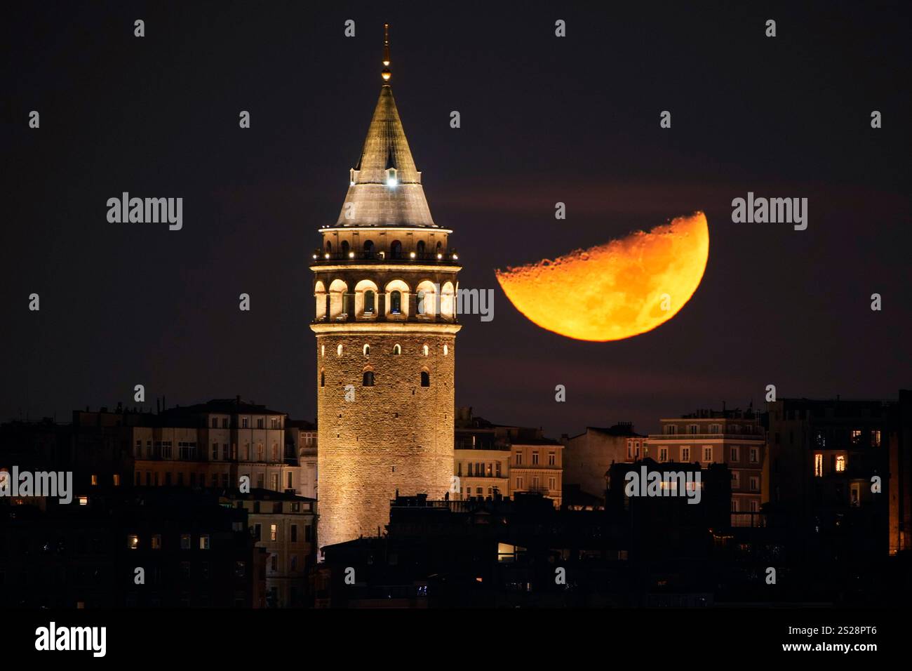 A half moon sets next to the Galata Tower in Istanbul, Tuesday, Jan. 7 ...