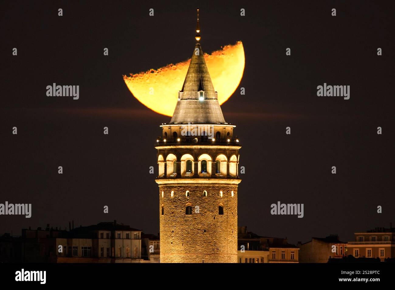 A half moon sets behind the Galata Tower in Istanbul, Tuesday, Jan. 7 ...