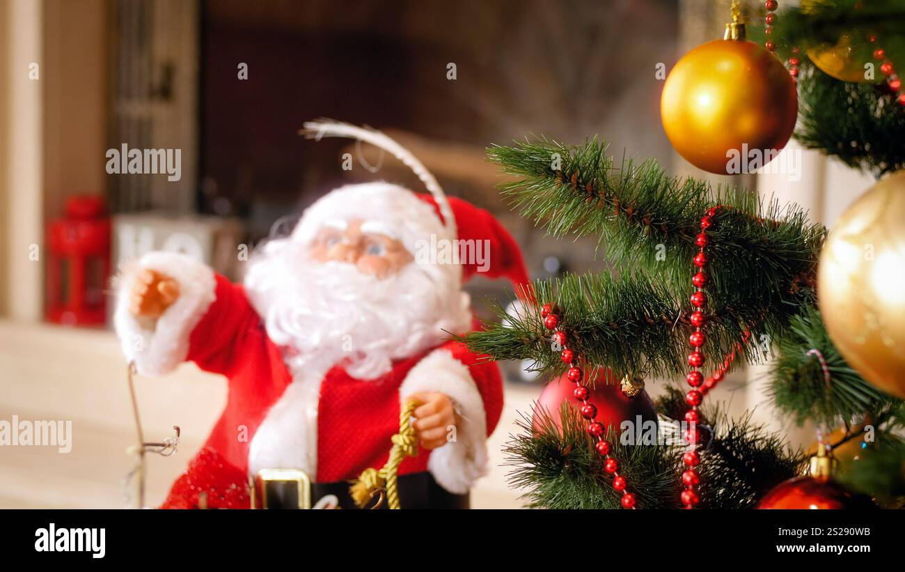 Closeup photo of Santa Claus figure and Christmas tree at living room ...