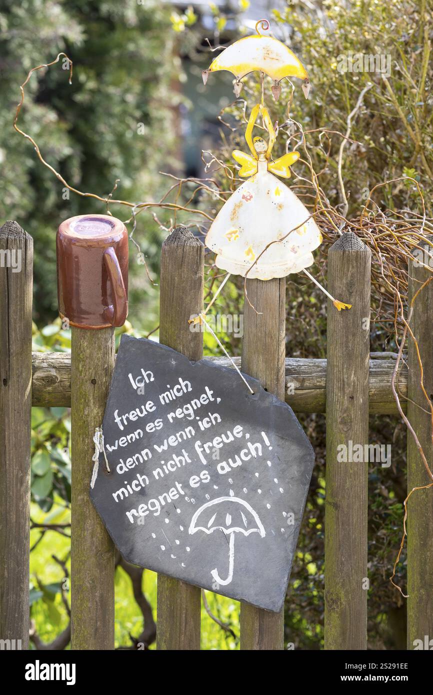 Picket fence decorated with a figure and a pot as well as a mindful verse about the rain, Altendorf, Sebnitz, Saxony, Germany, Europe Stock Photo