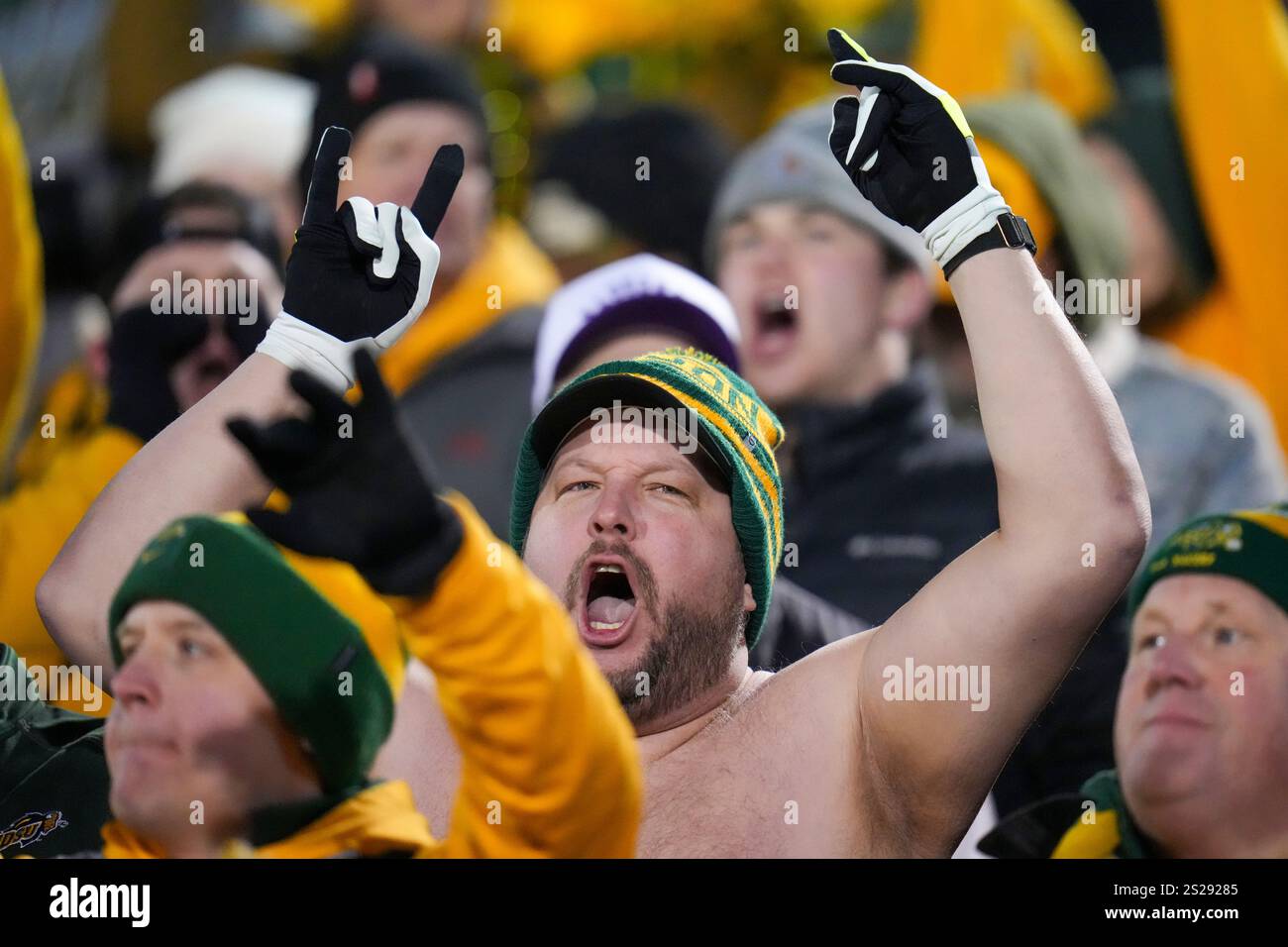 A North Dakota State supporter, center, braves nearfreezing