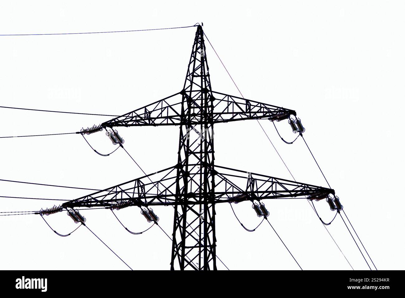 Power Line Side The pylon of a power line in front of a blue sky. High-voltage power ...