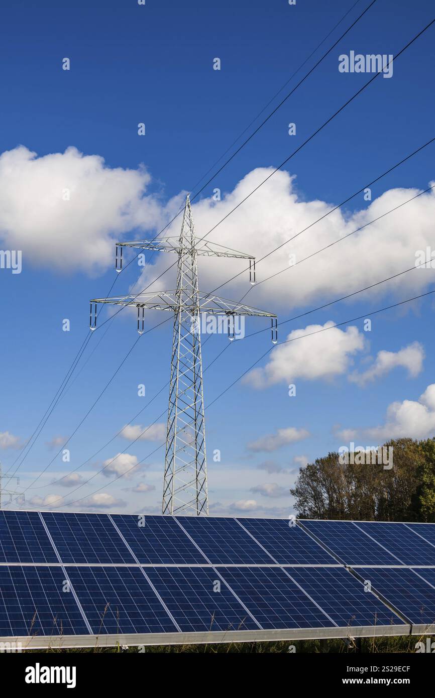 Panels for solar power and a power pole of a power line Stock Photo - Alamy