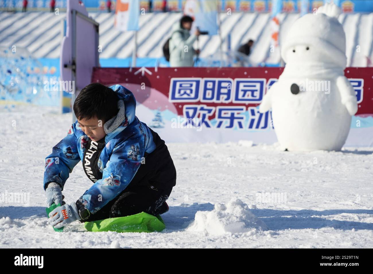 Children play the ice and snow games in Beijing Yuanmingyuan Park on January 4, 2025. Beijing,China.4th January 2025. Children play the ice and snow games in Beijing Yuanmingyuan Park on January 4, 2025. The 4th winter tourism season of Beijing Yuanmingyuan Park featuring entertainment projects on ice and snow has kicked off recently. Credit: Xiong Ran/China News Service/Alamy Live News Stock Photo