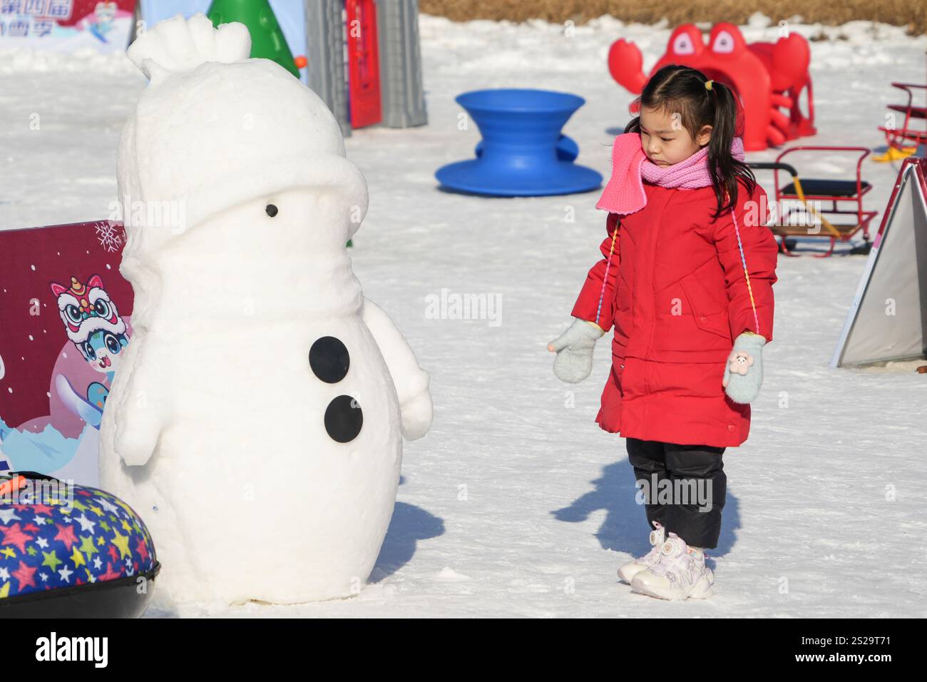 Children play the ice and snow games in Beijing Yuanmingyuan Park on January 4, 2025. Beijing,China.4th January 2025. Children play the ice and snow games in Beijing Yuanmingyuan Park on January 4, 2025. The 4th winter tourism season of Beijing Yuanmingyuan Park featuring entertainment projects on ice and snow has kicked off recently. Credit: Xiong Ran/China News Service/Alamy Live News Stock Photo