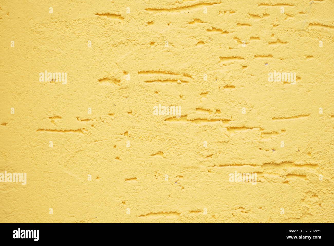 A beautifully textured yellow wall showcasing subtle and elegant patterns Stock Photo