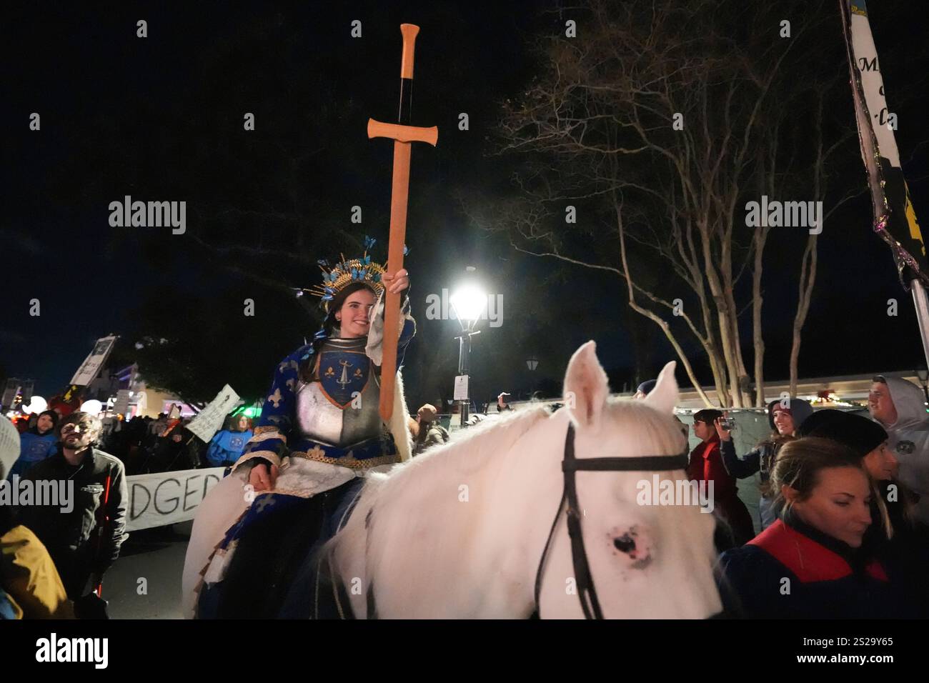 A person dressed as Joan of Arc rides a horse during the annual Krewe