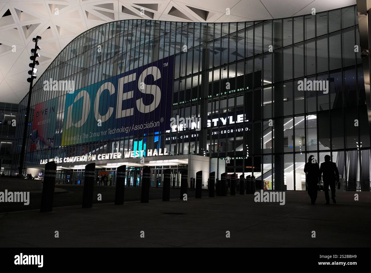 People walk by the Las Vegas Convention Center ahead of the CES tech