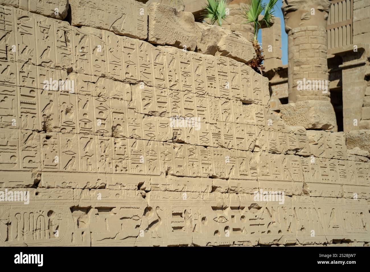 Egyptian ancient wall with carved hieroglyphs in the open air in Luxor ...