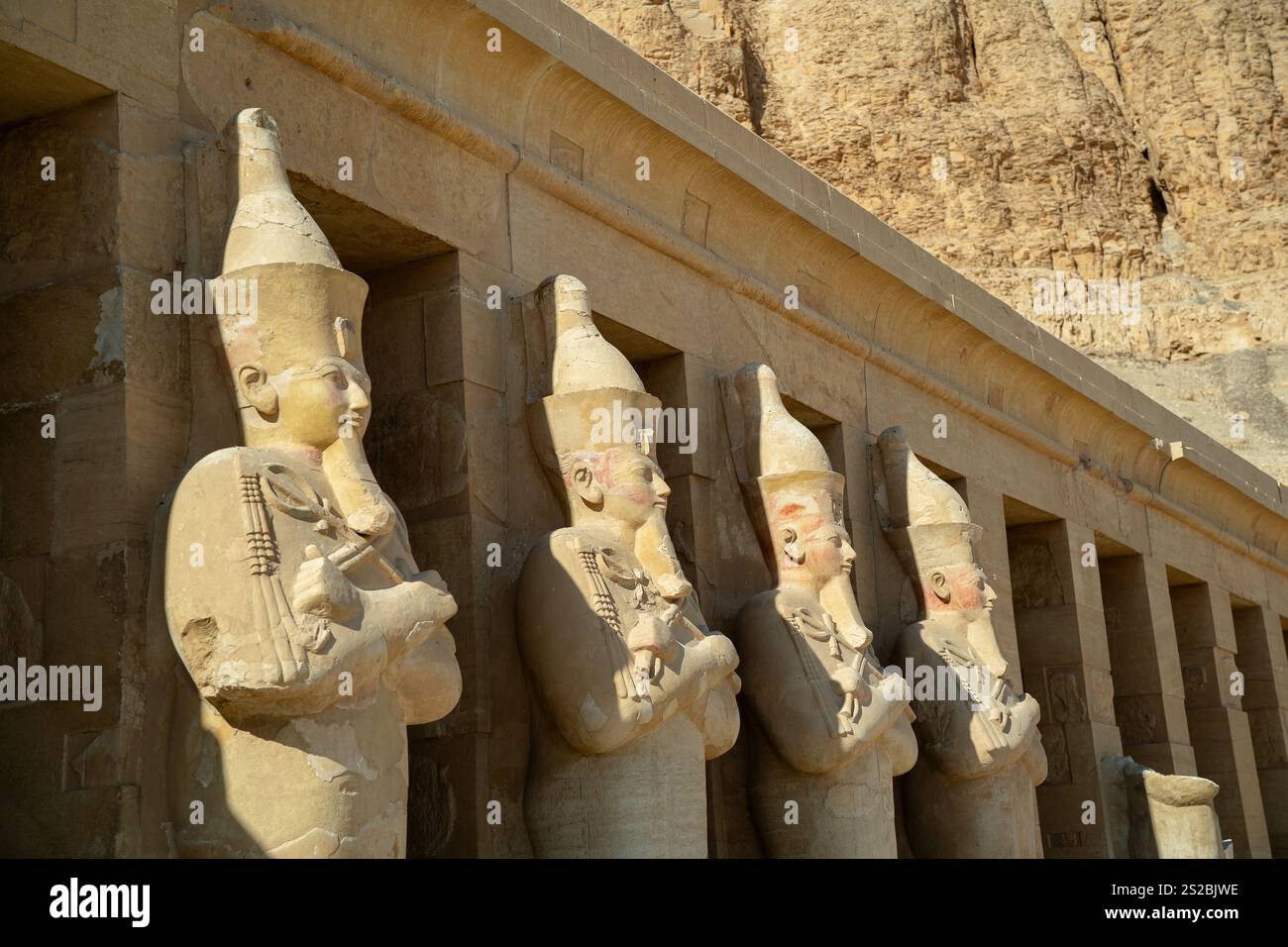 Statues of pharaohs near the walls of the ancient temple of Hatshepsut ...