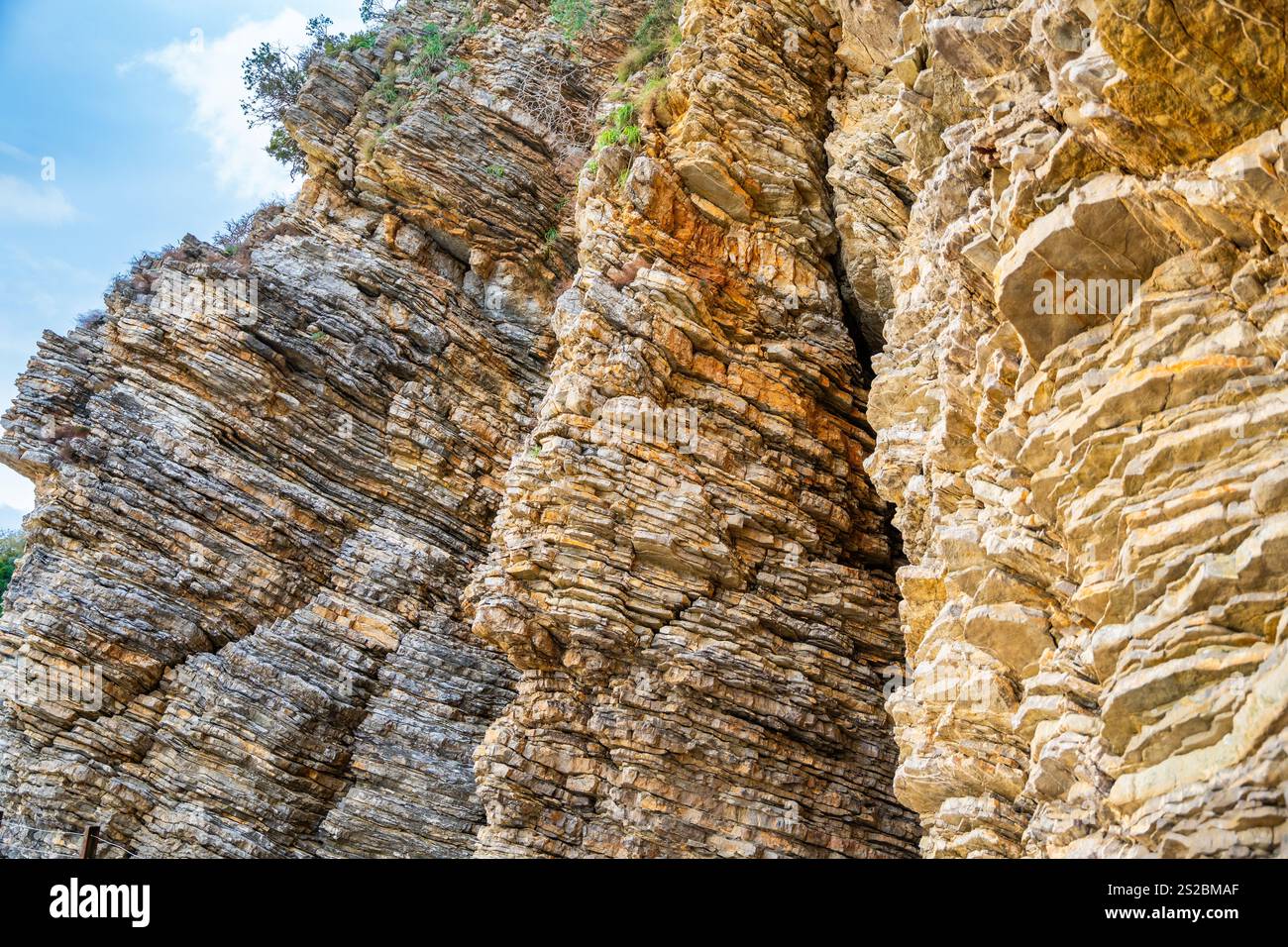 Layered rock texture in Budva, Montenegro. Sedimentary rocks with ...