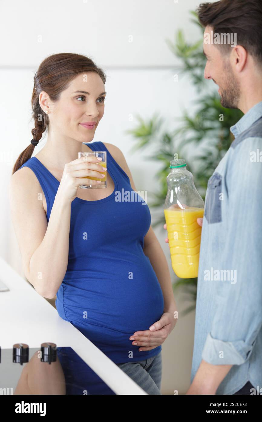 pregnant woman with glass of orange juice in the kitchen Stock Photo ...