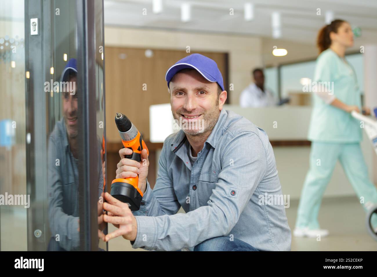 bearded man using hammer drill in a hospital Stock Photo