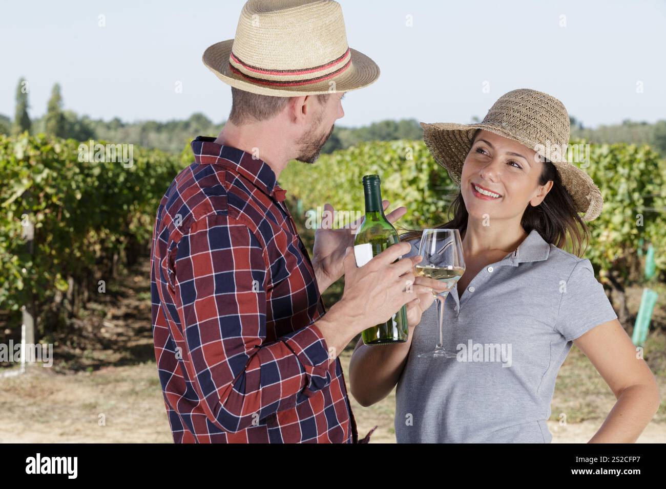 young couple tasting wine in vineyard Stock Photo
