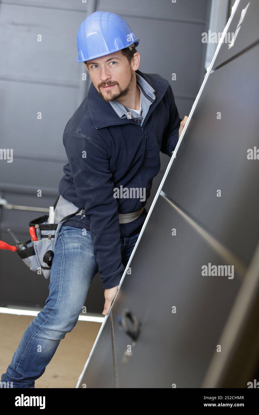 man builder is holding a door Stock Photo