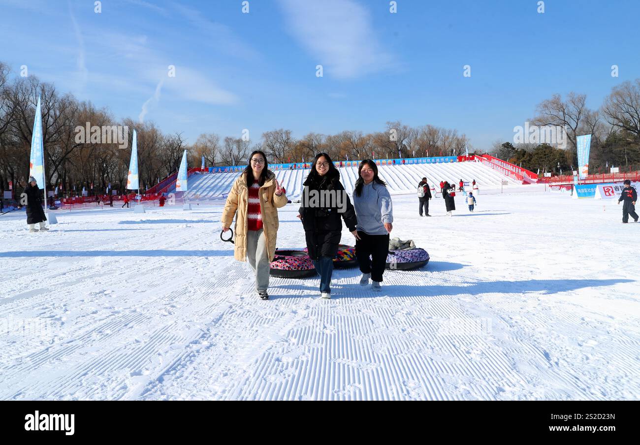 Tourists play at a snow park of the Old Summer Palace in Beijing, China