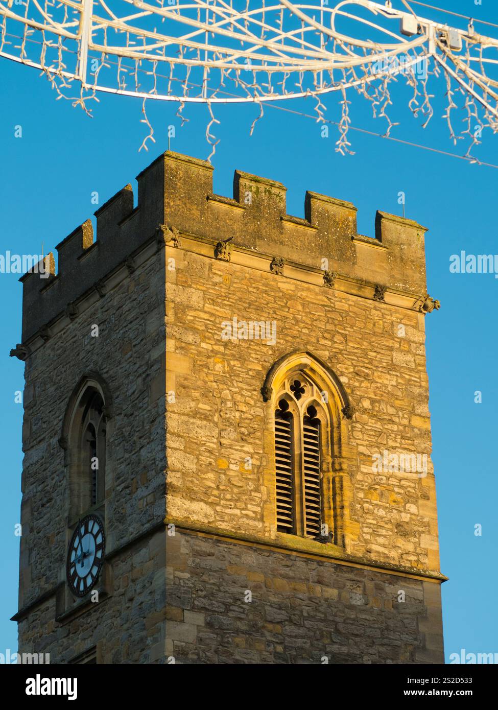 The bell tower of St Nicholas Church and Christmas decorations in ...