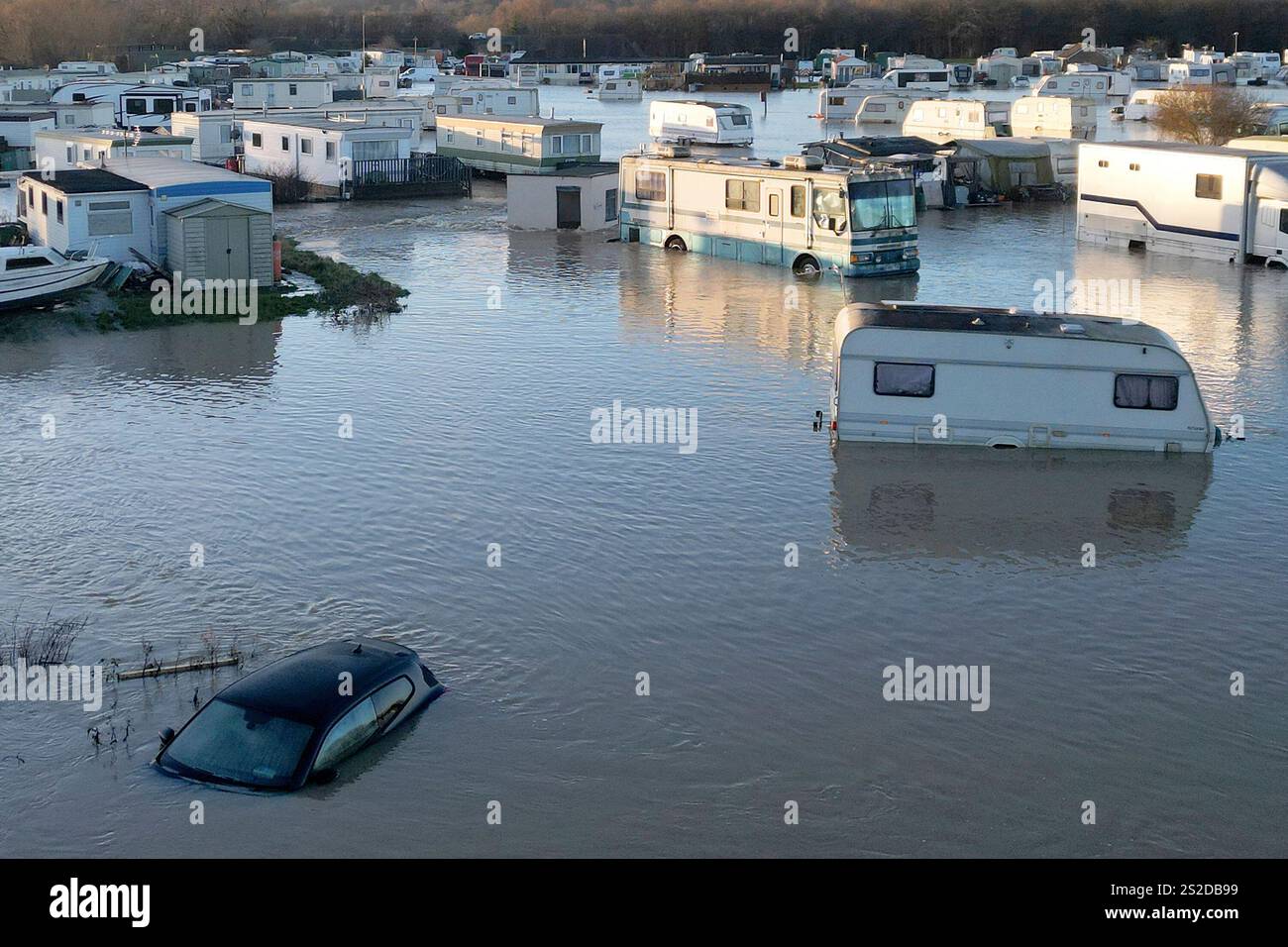 Caravans and cars sit in the floods of the river Soar in Barrow Upon