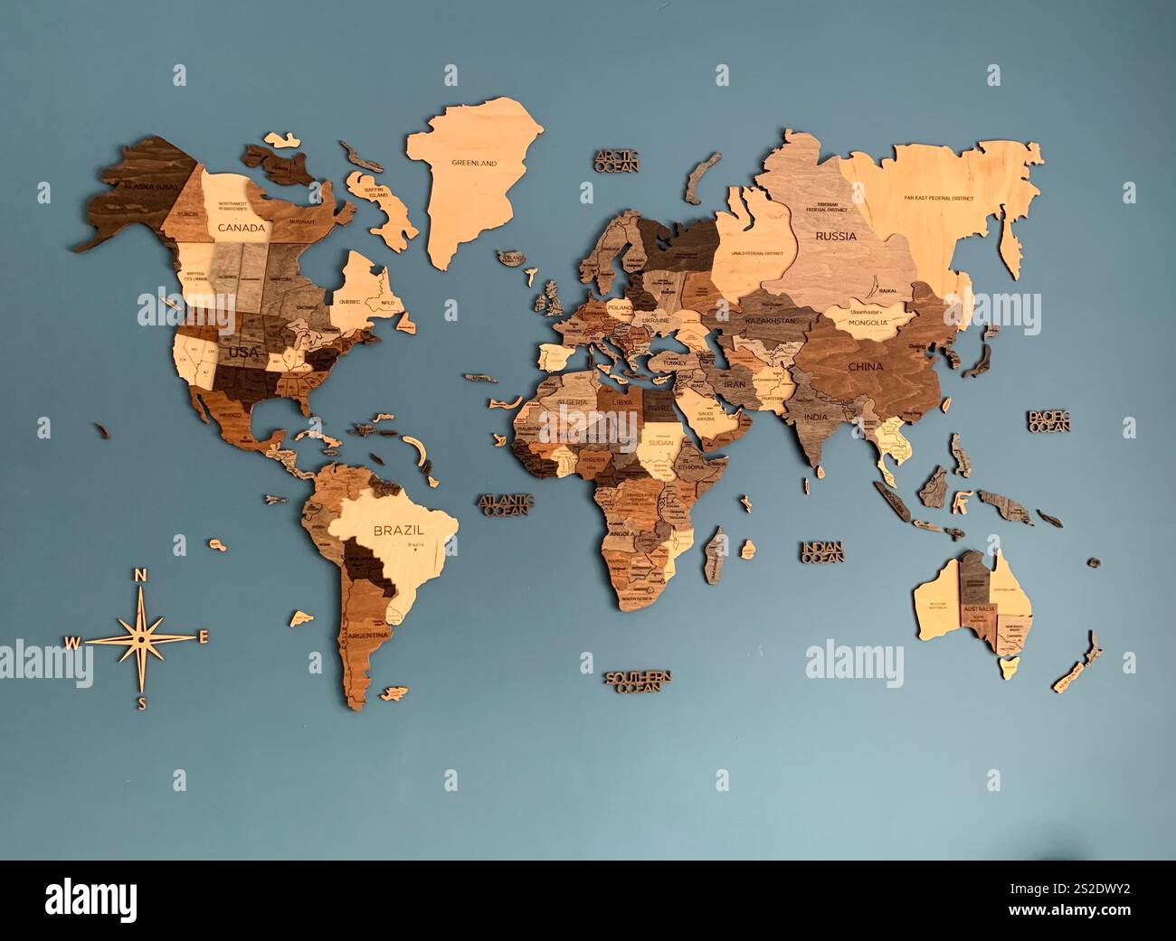 Map of the World on the wall with a blue background sea shape shapes continents Country Country's name names history historic place places view views - Smartphone Captured Stock Image