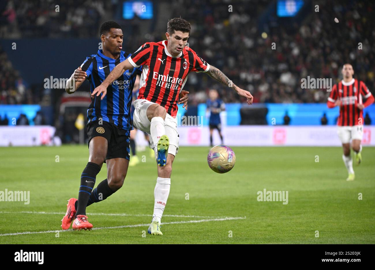 RIYADH, SAUDI ARABIA - JANUARY 6: Christian Pulisic of AC Milan competes for the ball with Denzel Dumfries of FC Internazionale ,during the Italian Super Cup Final match between FC Internazionale and AC Milan at Al-Awwal Park Stadium on January 6, 2025 in Riyadh, Saudi Arabia. (Photo by MB Media) Stock Photo