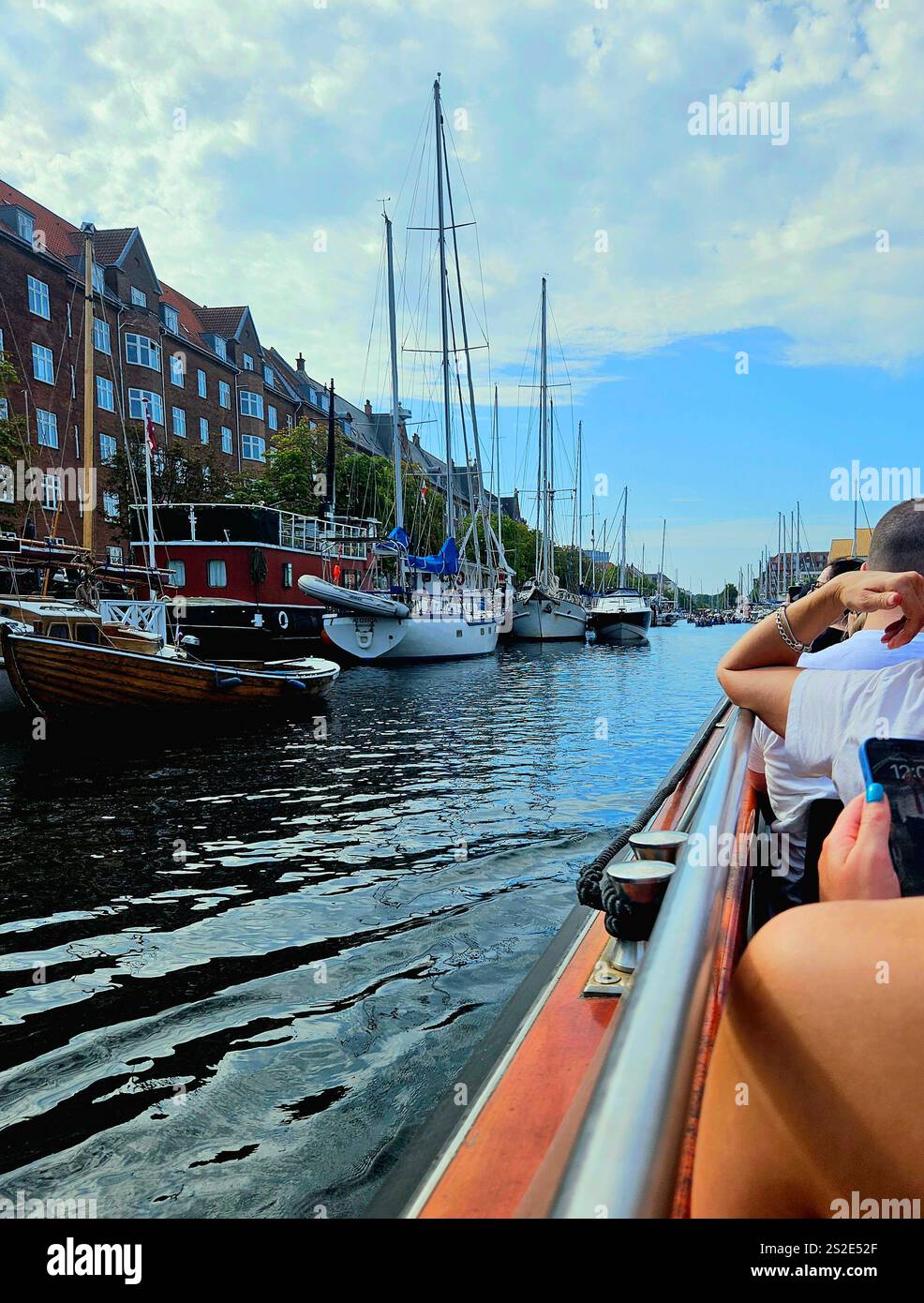 View from a Boat on a channel in Denmark with sail boats and buildings - Smartphone Captured Stock Image
