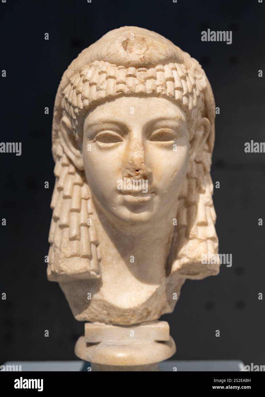 Close-up on head of ancient statue in marble portraiting a beautiful ...