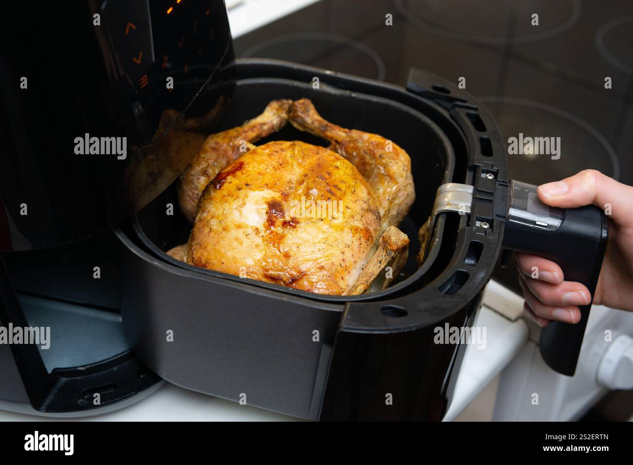 Cooking whole chicken in air fryer stock photo alamy