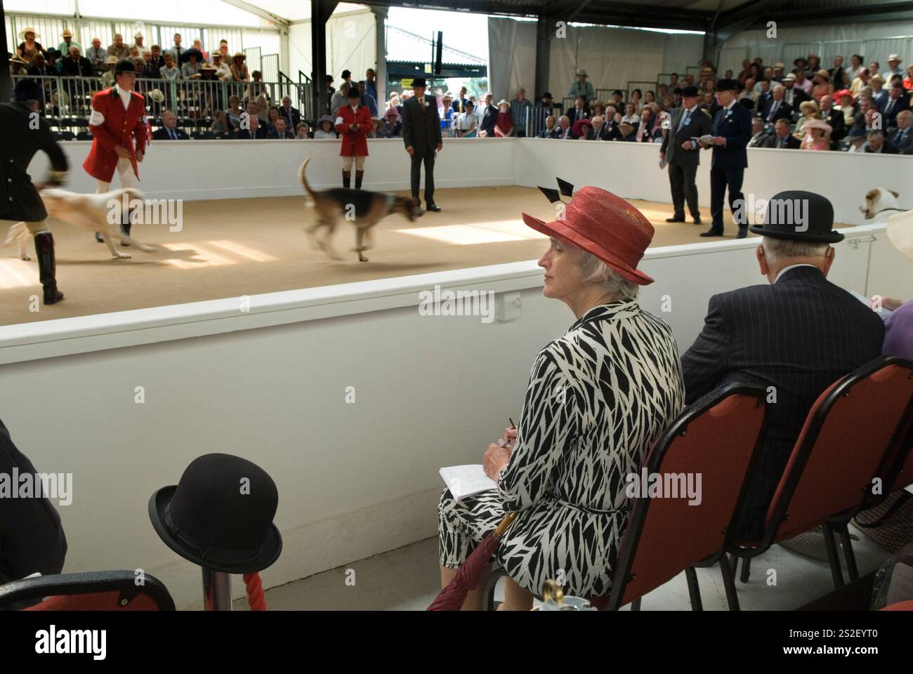 Bowler hat, Lady official taking notes sitting next to a judge wearing bowler at the Festival of Hunting 2010s Uk. Peterborough Royal Foxhound Show Society. English upper class country monied group of men and women watching the judging take place. Peterborough England 2013 HOMER SYKES Stock Photo