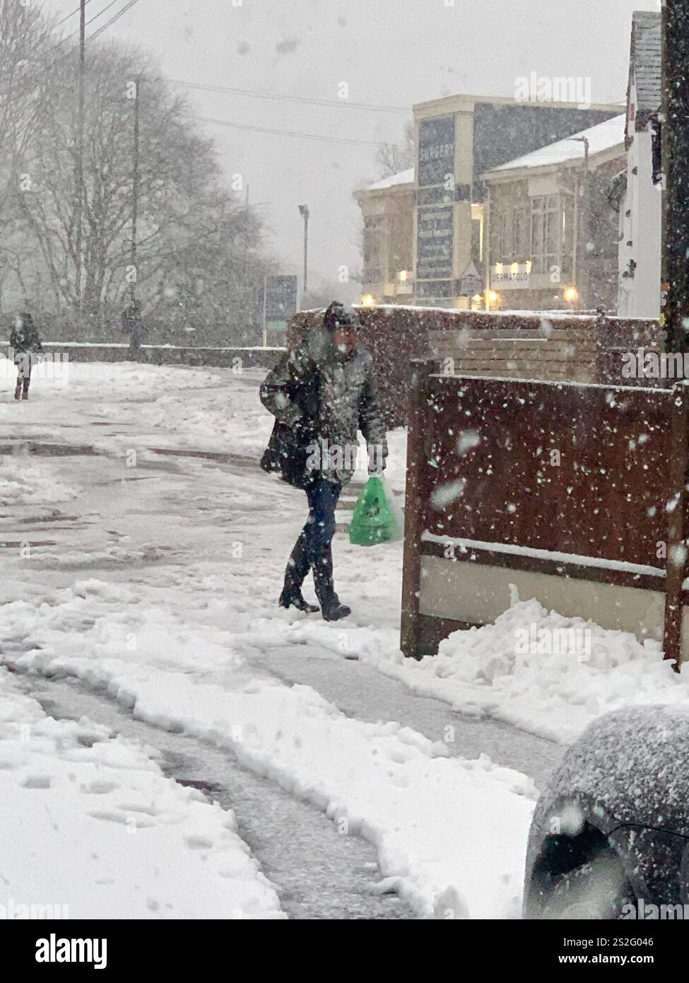 Guiseley North Yorkshire snow ice Weather Christmas clearing clear drive driveway place Town home live lived snowing storm Airport sludge spade man UK - Smartphone Captured Stock Image